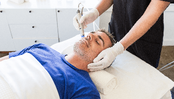A Man Having His Teeth Checked By Dentist