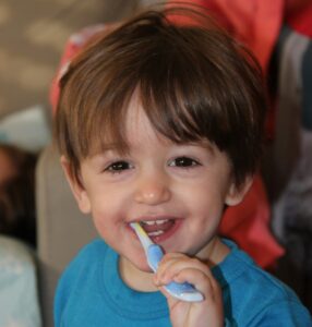 child brushing teeth