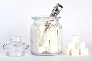 Close-Up Photo of Sugar Cubes in Glass Jar