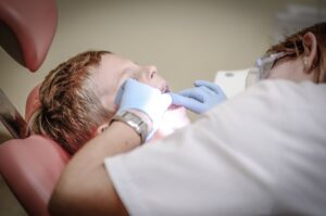checking a child's mouth and teeth dental treatment for a child