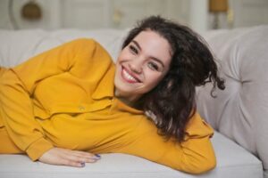 Woman in yellow top with a white smile