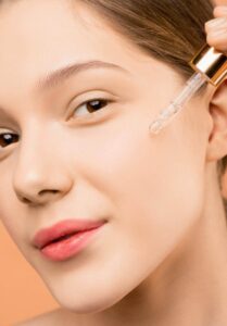 Woman applying anti-wrinkle facial serum with dropper for smooth skin